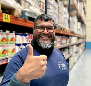 smiling happy employee of vamos a comer with uniform